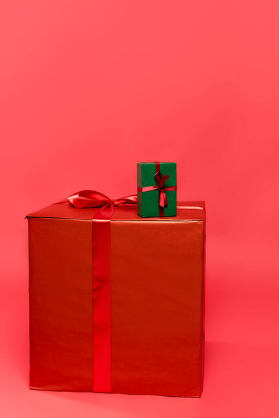 Gift boxes with ribbons on red background - Photo, Image