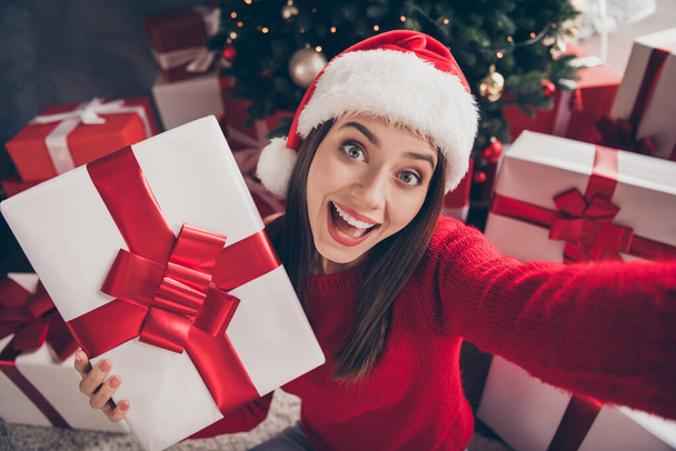 Self-portrait of her she nice attractive charming glad cheerful cheery girl holding in hand giftbox Eve Noel tradition having fun Saint Nicholas December sale in decorated house apartment indoor - 写真・画像