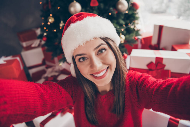 Self-portrait of her she nice attractive charming pretty lovely glad cheerful cheery girl wearing festal cap Eve Noel tradition having fun leisure in decorated house apartment indoor - 写真・画像