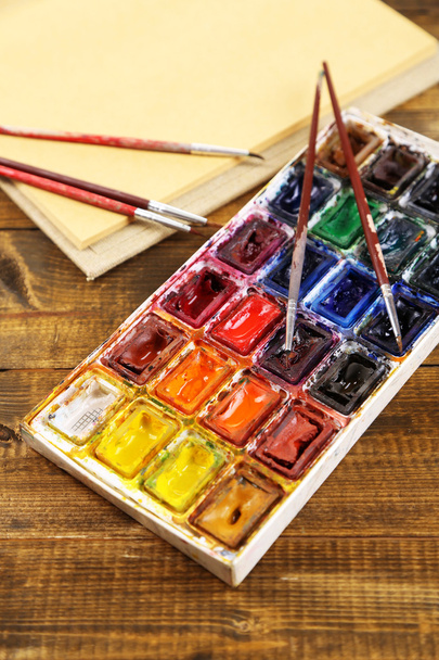 Composition with colorful watercolors, brushes and sketcher on wooden background  - 写真・画像