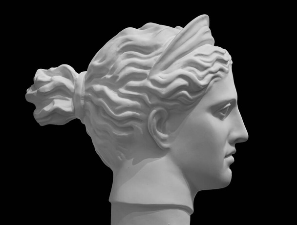 White marble sculpture head of young woman. Statue of sensual renaissance art era naked woman in circlet antique style isolated on black background - Photo, Image