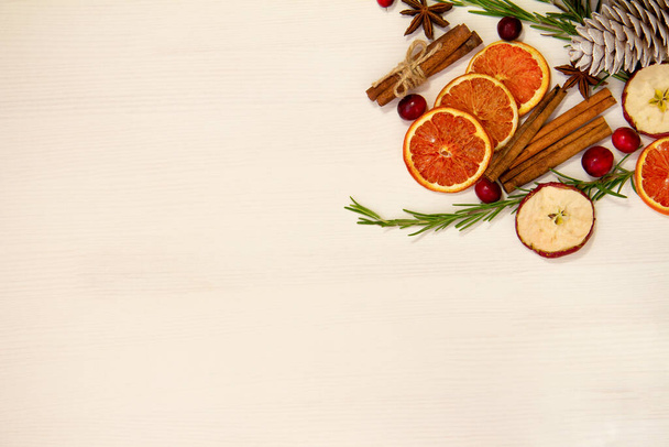 Christmas food on a white background. Ingredients for cooking - cranberries, rosemary, orange and anise on a white background. Top view copy space - Φωτογραφία, εικόνα