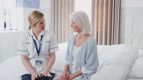 Vrouwelijke arts maakt huisbezoek aan oudere vrouw voor medische controle - schot in slow motion - Video