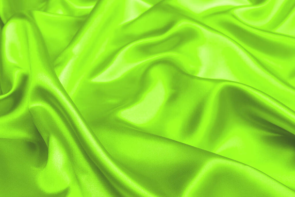 UFO tela de satén verde textura suave fondo borroso - Foto, Imagen