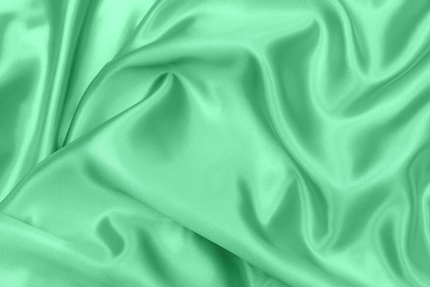vert satin tissu texture doux fond flou - Photo, image