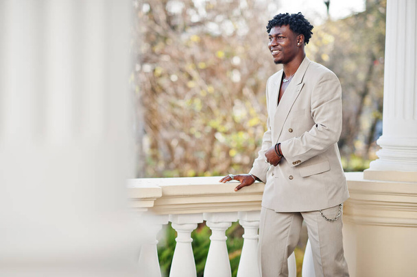 Elegante afro uomo in abito beige vecchia scuola. Giovane africano alla moda in giacca casual sul torso nudo. - Foto, immagini