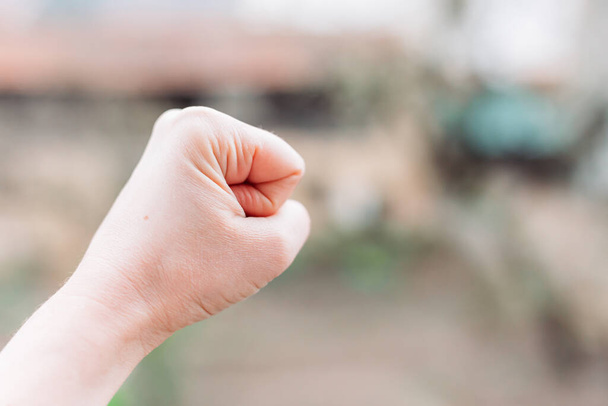 Close-up photo of female fist. Fight for women rights. Space for text - Foto, Bild