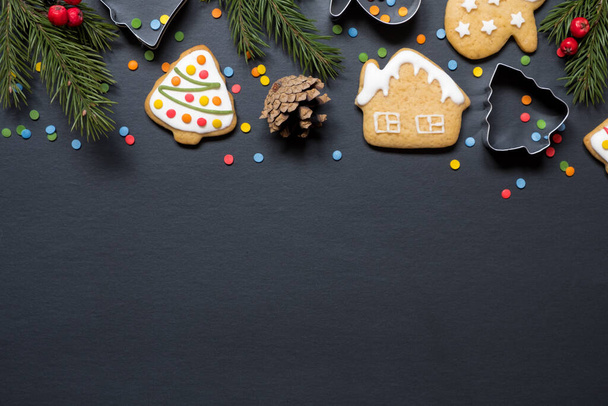 Forms for cooking and christmas cookies on black background with copy space. - Foto, imagen