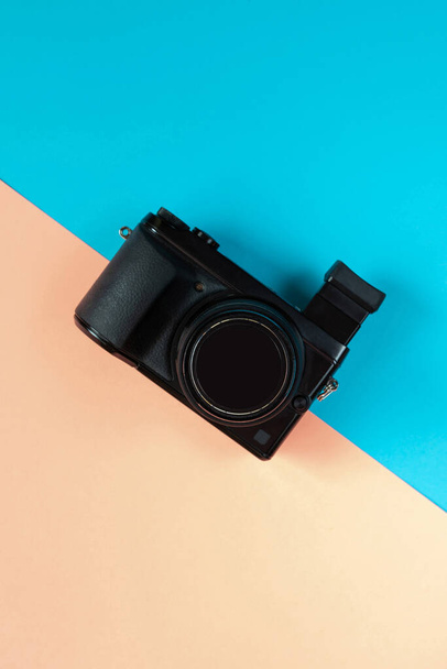 Flat lay of camera on blue and pink background - Photo, Image