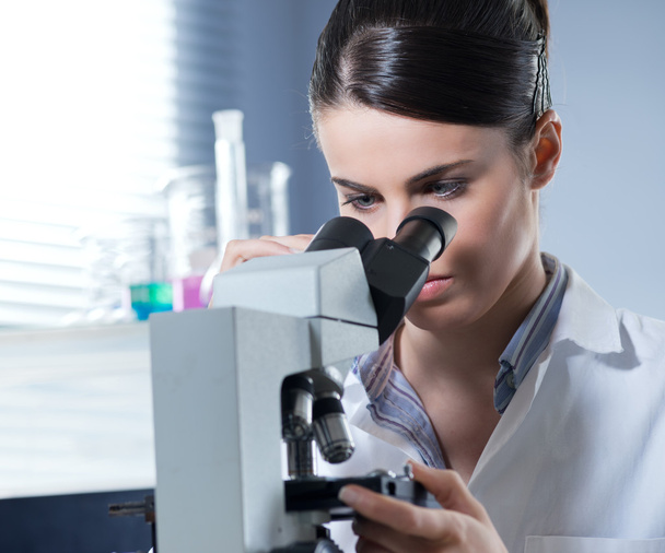 Female researcher using microscope - Фото, изображение