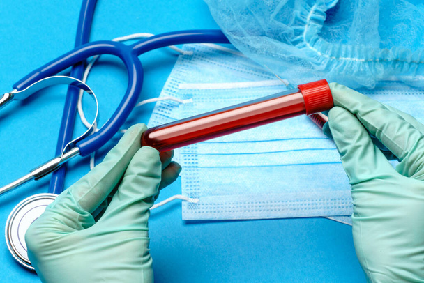 lab technician assistant or doctor holding a blood sample in test tube - Foto, Imagem