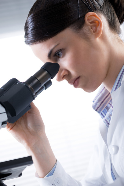 Female researcher using microscope close up - Fotó, kép