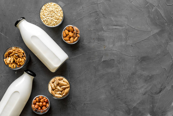 Vegan alternative nuts milk in bottles. Above view - Zdjęcie, obraz