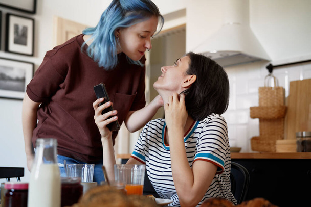 Happy lesbian couple in the kitchen                                - Photo, image