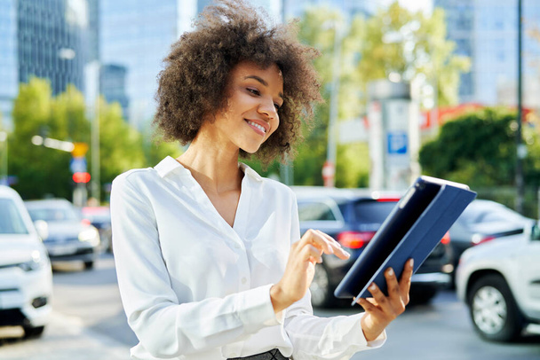 Glückliche Geschäftsfrau mit digitalem Tablet in der Stadt                                - Foto, Bild