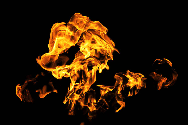 Fire flames on black background isolated. Burning gas or gasoline burns with fire and flames. Flaming burning sparks close-up, fire patterns. Infernal glow of fire in the dark with copy-space - Valokuva, kuva