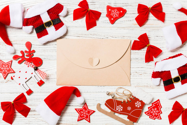 Top view of envelope on festive wooden background. Christmas toys and decorations. New Year time concept. - Photo, Image