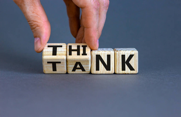 Think Tank concept. Blocks form the expression 'think tank'. Male hand. Beautiful grey background. Business concept. Copy space. - Фото, изображение