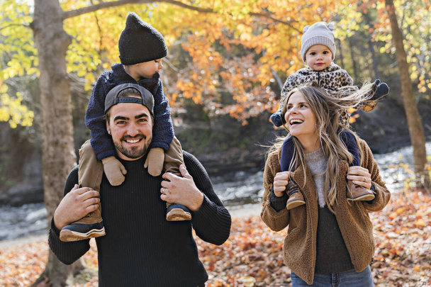 Family Group Relaxing Outdoors In Autumn Landscape - Foto, Imagen