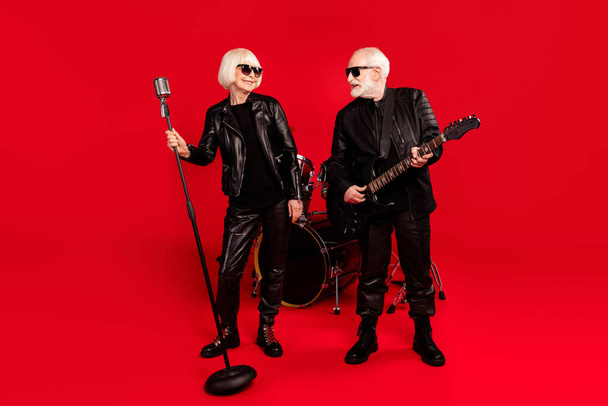 Full length photo two people wife husband retired pensioner rock fan woman singer solo man play bass guitar look enjoy studio tour garage practice event isolated bright shine color background - Fotografie, Obrázek