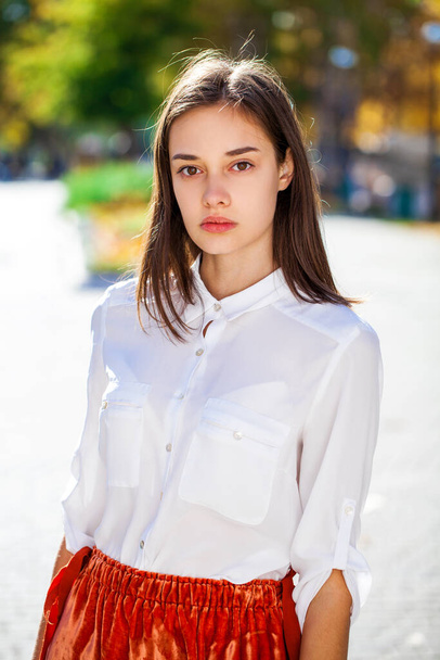Close up portrait of a young beautiful girl in white shirt - Photo, image