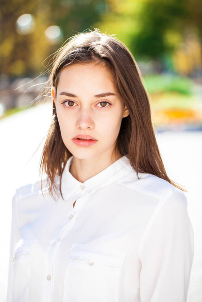 Close up portrait of a young beautiful girl in white shirt - Photo, Image