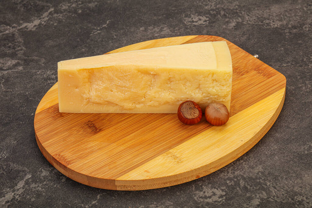 Tasty parmesan cheese with hazel nut over wooden - Photo, Image