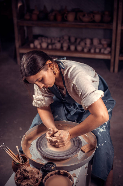 Affascinante donna ceramista scolpisce da argilla. Produzione artigianale. - Foto, immagini