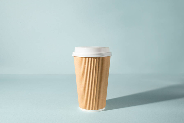 Paper cup of coffee on black background. Side view. Take away cup. Horizontal orientation. - 写真・画像