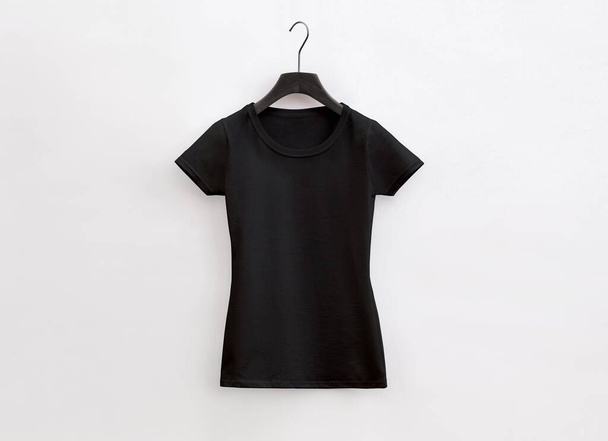 lady fit cuello redondo camiseta negra con percha sobre fondo blanco - Foto, Imagen