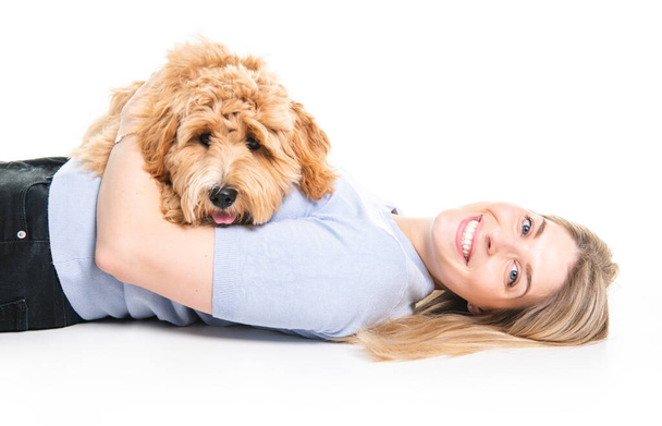 woman with his Golden Labradoodle dog isolated on white background - Foto, afbeelding