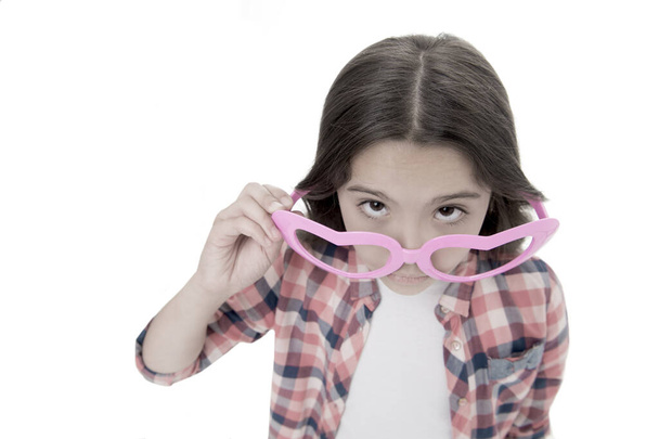 Who are you. Schoolgirl heart shaped glasses isolated white background. Child serious girl picking out of eyeglasses copy space. Child smart kid wondering face close up. Suspicious concept - Fotó, kép
