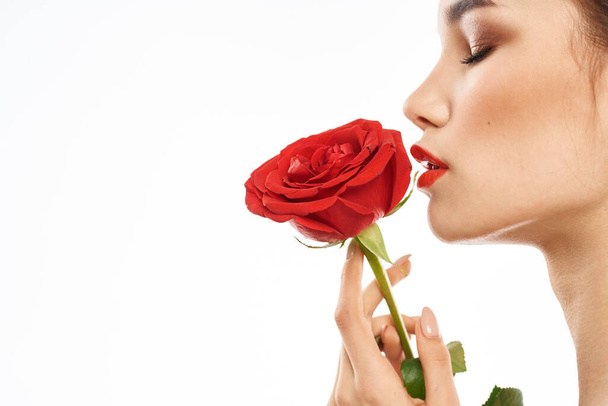 Beautiful woman with red rose near face makeup naked shoulders portrait - Foto, imagen