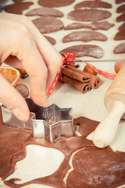Vintage photo, Cookie cutters with dough for preparation Christmas cookies or gingerbread, festive time concept - 写真・画像