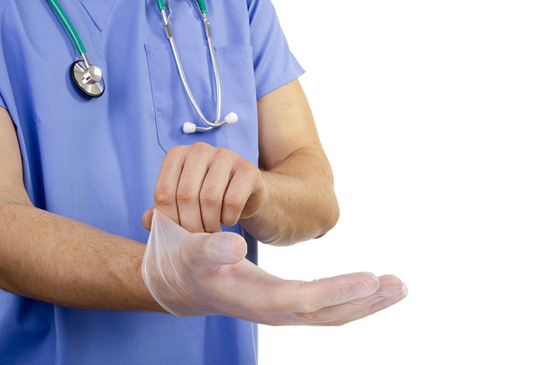 Arzt zieht Handschuhe an - Foto, Bild
