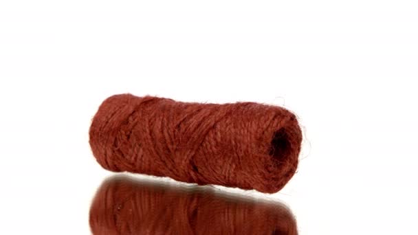 Skein of red jute twine rotating on isolated white background. Natural recycled - Footage, Video