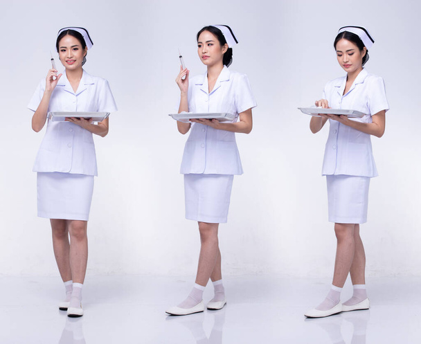 Full body length Figure snap of 20s Asian Woman wear Nurse White uniform pants skirt and shoes, white Background isolated - Photo, Image