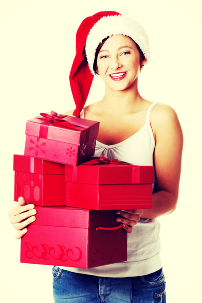 Teen girl holding gifts. - Φωτογραφία, εικόνα