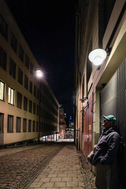 Stockholm, Sweden Oct 30, 2020 A man smoking on Karduansmakargatan in the downtown. - Zdjęcie, obraz