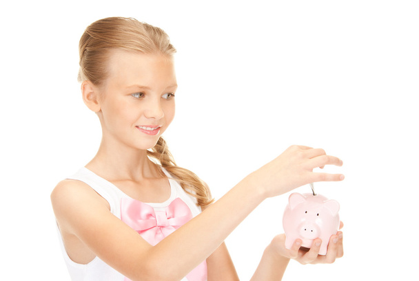 Lovely teenage girl with piggy bank and money - Foto, imagen