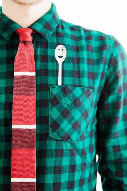 Homem com gravata e uma colher no bolso
 - Foto, Imagem