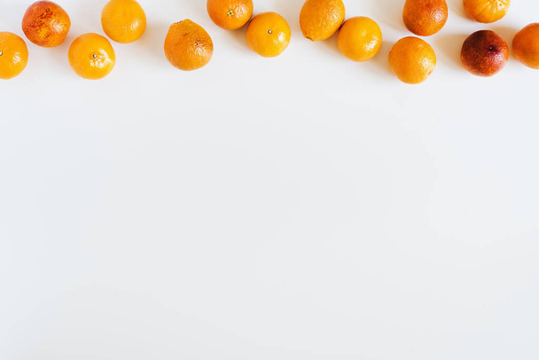 Oranges and mandarin on white background, overhead view. Food frame composition. Space for text, recipe - Фото, изображение