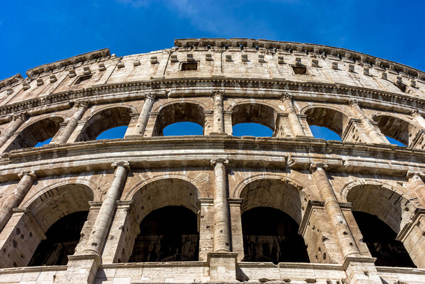 Facade of the Great Roman Colosseum (Coliseum, Colosseo), also known as the Flavian Amphitheatre. Famous world landmark. Scenic urban landscape. - Photo, Image