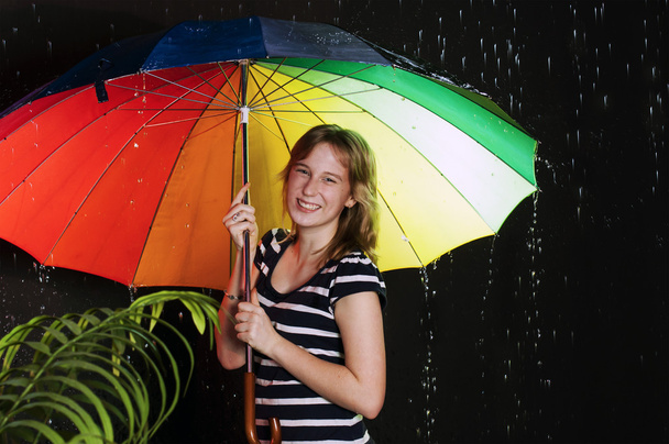 Smiling girl with colorful umbrella - Фото, изображение