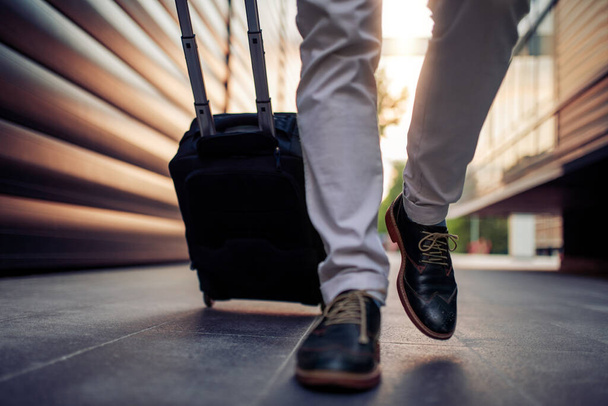 Close up of man with suitcase.Business, travel and tourism concept. - Фото, изображение