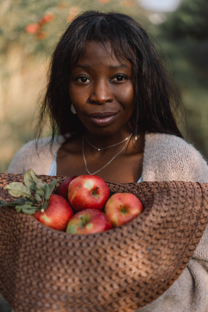 Portrait Afro woman in Apple Orchard. African ethnicity. Lifestyle - Photo, Image