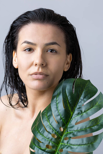 Beauty Woman with natural green palm leaf portrait. Fashion, beauty, make-up, cosmetics. - Fotografie, Obrázek
