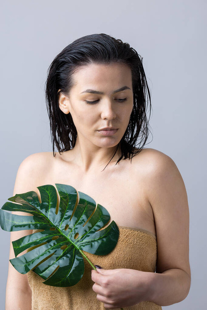 Beauty Woman with natural green palm leaf portrait. Fashion, beauty, make-up, cosmetics. - Photo, Image