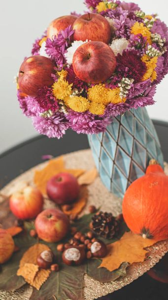Autumn bouquet of flowers and apples. Autumn bright background with apples, chrysontema, dry leaves. September October November. Seasonal autumn background with yellow and orange colors. - Fotó, kép