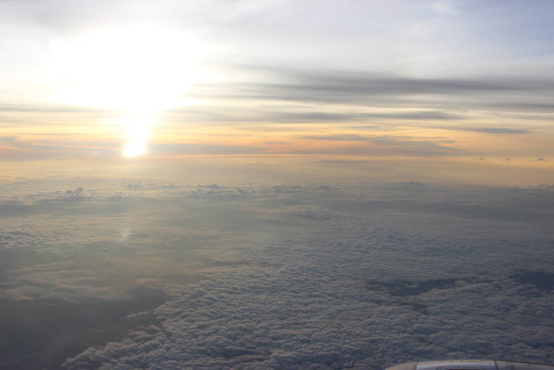 Beautiful sunset over the clouds from the sky - Photo, Image